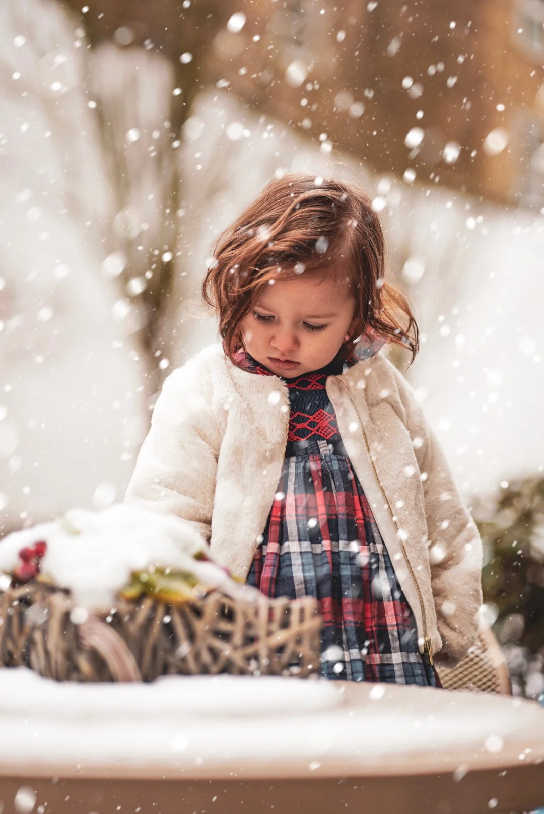 Amelie playing in the snow in her handmade Ninon smocked dress