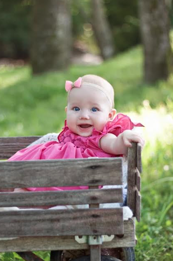 Caroline wearing a pink Netti smocked dress