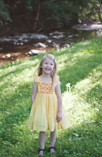 Savannah wearing a Sunshine Netti smocked dress