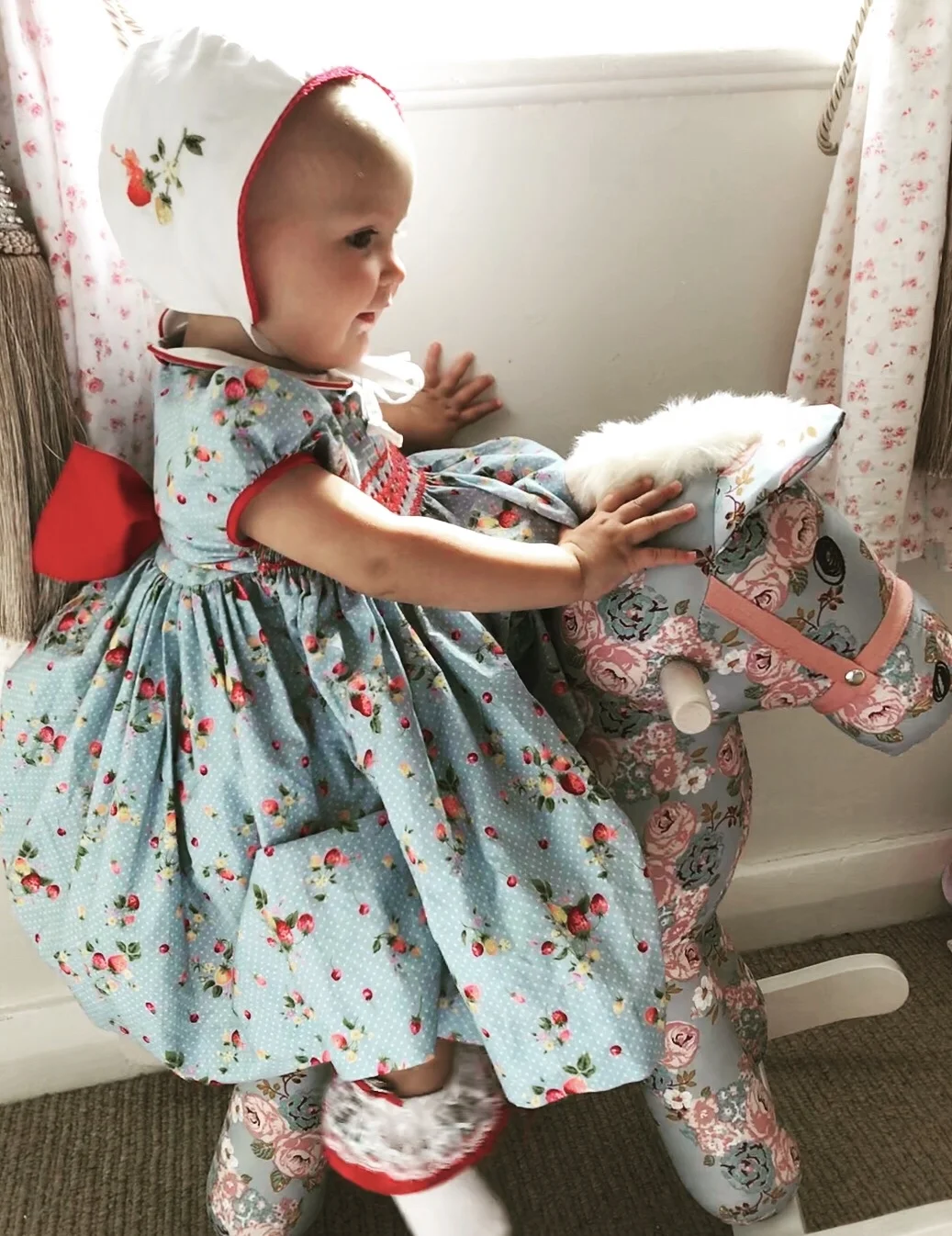 Hâf wearing a handmade smocked dress