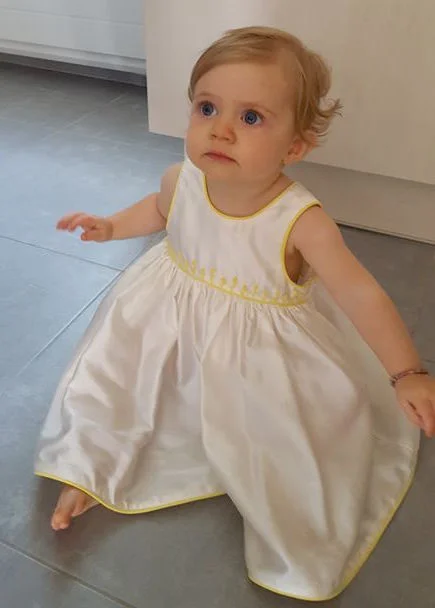 Darling baby Iris in a white handmade embroidered dress